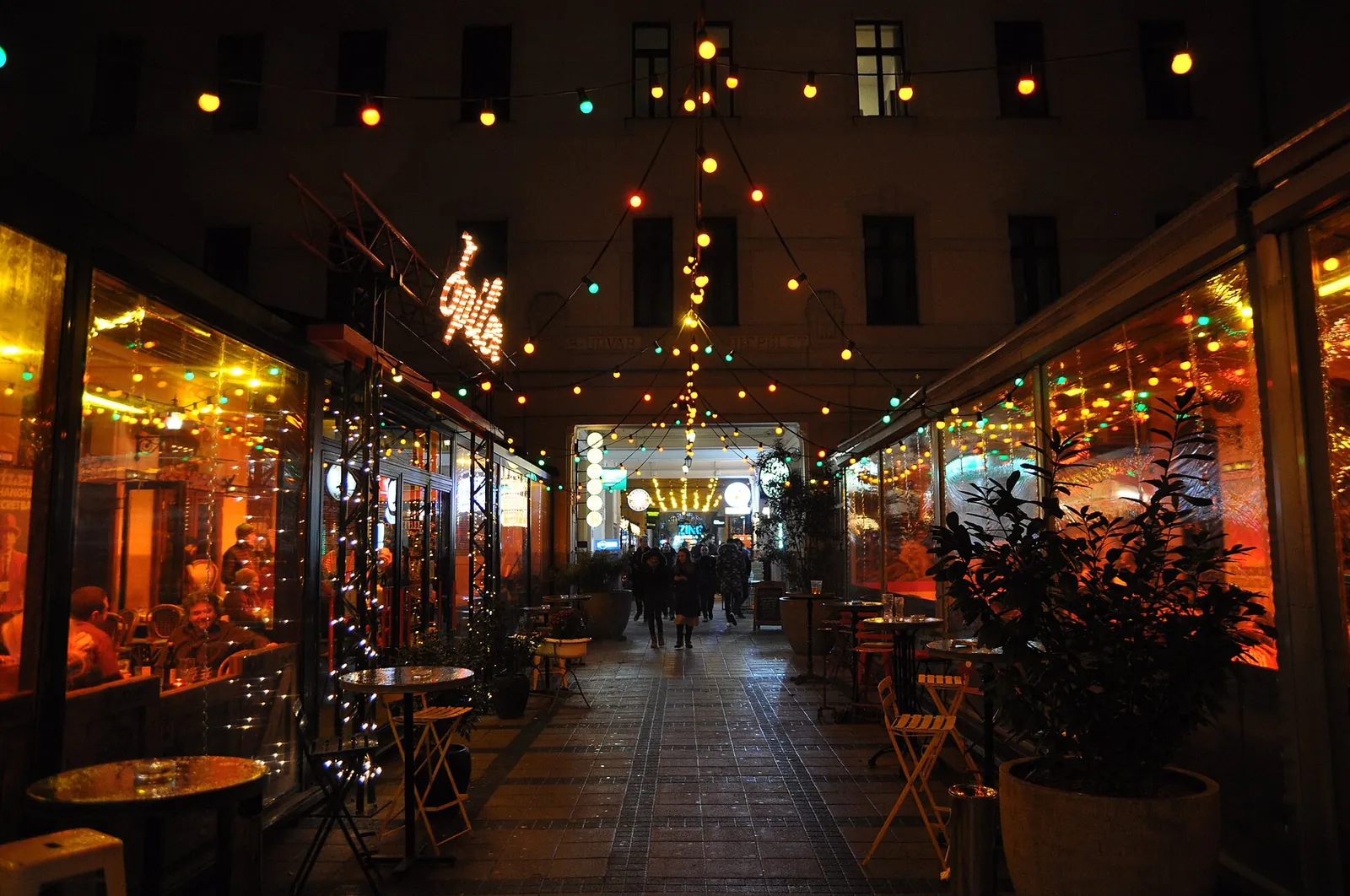 Gozsdu Udvar at night with string lights and terraces, home of the Gozsdu Mission escape rooms in Budapest